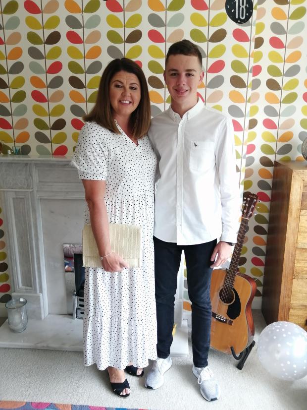 Glasgow Times: Beverley Voukelatos, 50, with son Elias, 18. Beverley's colleagues at Glasgow's Queen Elizabeth University Hospital took care of her mum and son while she was abroad.