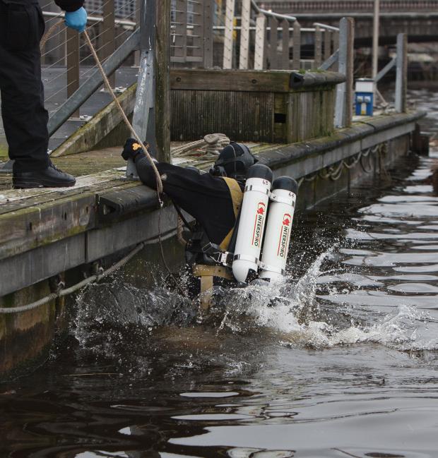 Glasgow Times: Members of the Police Dive and Marine unit pictured on the River Clyde at the Broomielaw in Glasgow. Pictured is  police diver Louise Muir entering the water from the pontoon...Photograph by Colin Mearns.16 March 2022.For Glasgow Times, see story by Cat
