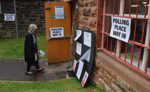Glasgow Times: Pictured is a person arriving to vote at the polling place at Pollokshields Burgh hall in Glasgow for the council elections