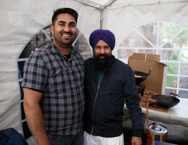 Glasgow Times:  Lakhvir Singh pictured with his father Valdev Singh. Valdev was making pakora and Lakhvir was serving the food from a stall on kenmure Street today, Saturday. Lakhvir was one of the two men who were released from an immigration van on Kenmure Street last year