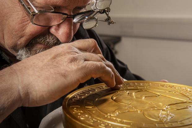 Glasgow Times: Master craftsman Steve Dyer works on the 15 kilo gold coin by hand. Credit: The Royal Mint