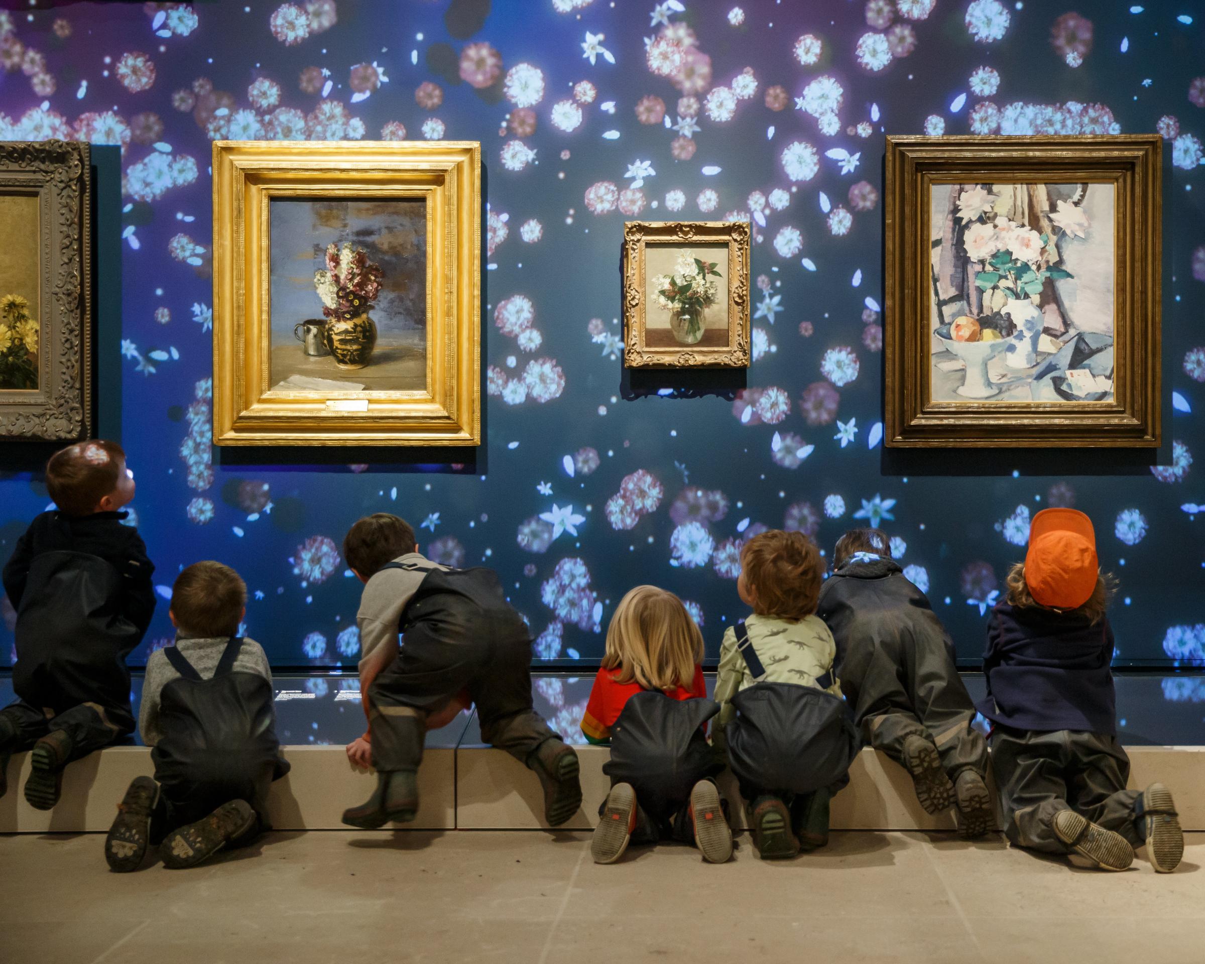 Children from the Woodland Outdoor Kindergarten looking at paintings. Photograph by Colin Mearns.