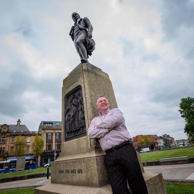 Glasgow Times: Pictured: The new Tannahill Makar for Renfrewshire, Shaun Moore, t the statue of Paisley poet, Robert Tannahill