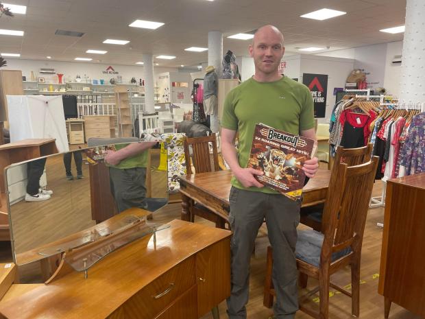 Glasgow Times: Pictured: Assistant shop manager Robert Sutherland stands with items donated by Borderland film crews