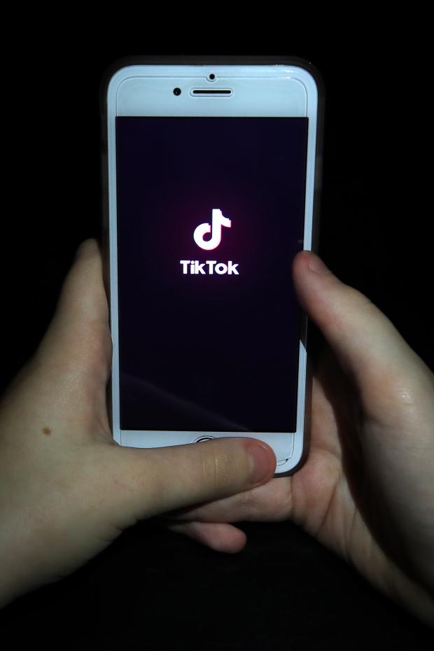 Glasgow Times: A person with TikTok open on their phone. Credit: PA