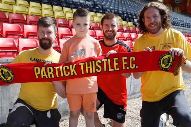 Jags For Good members Ross Millar, left, and Neil Cowan, right, pose with Thistle captain Ross Docherty and eight-year-old Oakwood Primary School pupil Archie, who received a season ticket on Thursday (PHOTO: COLIN MEARNS)