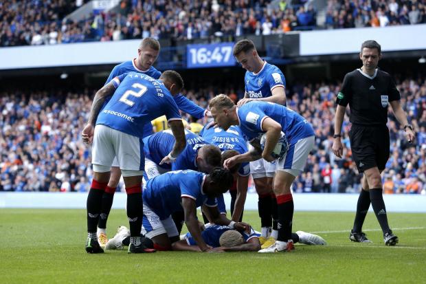 Rangers' Alfredo Morelos (hidden) celebrates scoring their side's second goal of the game with team-mates during the cinch Premiership match at Ibrox