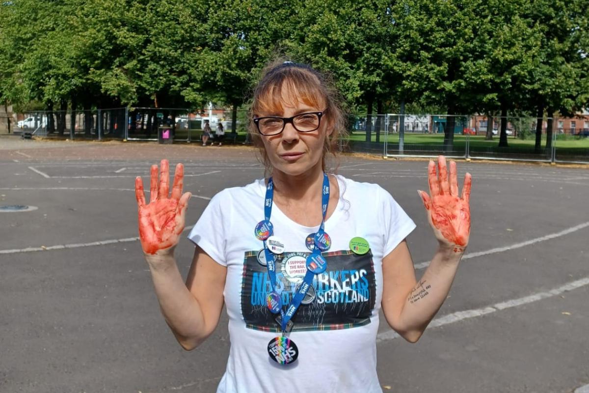 Ex-nurse covers hands in 'blood' during march in rejection of NHS pay rise offer