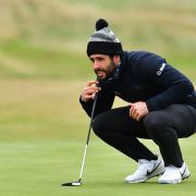 Adrian Otaegui of Spain lines up an eventual birdie putt on the 18th green to finish -10 under par for his first round