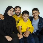 Zabidullah Rasoli pictured with his wife Tabasum at home in Glasgow, alongside Tabasum's nephews, Mohammad age 6 and Zekrullah age 16