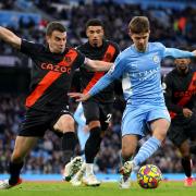 Manchester City's James McAtee (right) and Everton's Seamus Coleman battle for the ball during the Premier League match at the Etihad Stadium