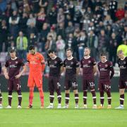 Hearts players observe a minute's silence before the start of the second-half at Tynecastle