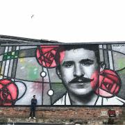 Rogue One (aka Bobby McNamara) with his Mackintosh mural on the banks of the Clyde