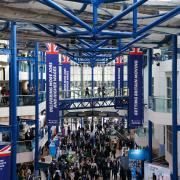Delegates walk through the conference hall during the Conservative Party annual conference at the International Convention Centre in Birmingham earlier today