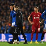 Connor Goldson of Rangers reacts while leaves the pitch after receiving medical treatment during the UEFA Champions League group A match between Rangers FC and Liverpool FC