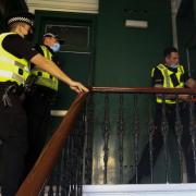Cops raid Glasgow flat after 'incident' in Edinburgh