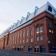 TV star poses outside Ibrox Stadium with Rangers scarf