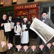 Niall Murphy,  with map, and Rachel Kacir, left, of director of Glasgow City Heritage Trust, with pupils