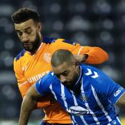 Kyle Vassell holds off Connor Goldson