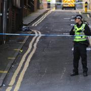 Generic image of police officer next to cordon