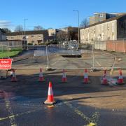 Sinkhole swallows road after burst sewer main erupts