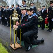 Members of the Sea Cadets ring the bell to honour the memory of those lost