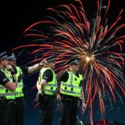 Generic image of police officers and fireworks