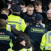 Police and stewards attempt to control the crowd at Tynecastle on Wednesday night