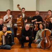L-R: Accordionist Neil Sutcliffe, Freed Up Director Donna Boyd, violinist Roo Geddes, b assist Ewan Hastie, Scottish rapper MOG and the Glasgow Barons Quartet comprising Aaron McGregor, Marina Sánchez Cabello, Liam Brolly and Emma Donald