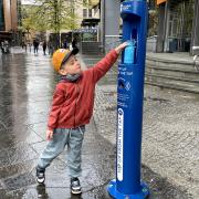 Finn Rush (4) tops up his water bottle from the new tap outside Buchanan Bus Station