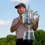 Xander Schauffele holds the Wanamaker Trophy after winning the US PGA Championship (Sue Ogrocki/AP)