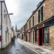 Stromness in Orkney is known for its narrow main street which hugs the coast