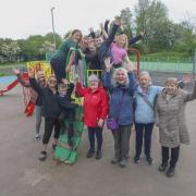 Pupils and staff from Knightswood Primary with local residents at the newly repainted and repaired Temple Park