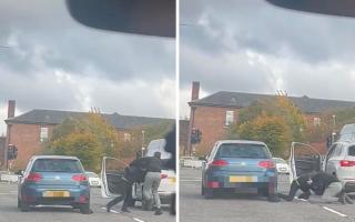 Two men seen getting out of their cars on busy road to start 'scrapping'
