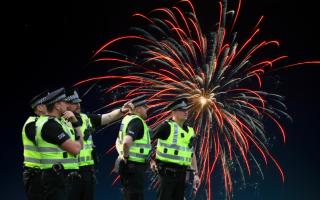 Generic image of police officers and fireworks