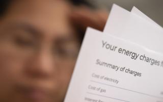 Generic image of a person holding an energy bill