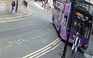 Incredible video shows man being hit by bus as he crosses road – before walking away with bruises