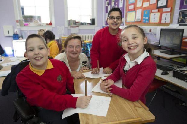 Callum Devine, classroom assistant Faith Taylor, Rehman Ashraf and Courtney Cassidy are all smiles  during their lessons                                                                                  Pictures: Robert Perry