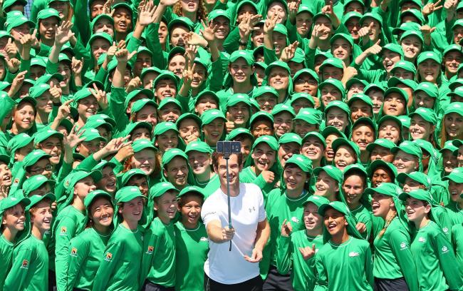 MELBOURNE, AUSTRALIA - JANUARY 12:  Andy Murray of Great Britain takes a selfie with ballkids from Australia and overseas during the annual ballkid team photo ahead of the 2016 Australian Open at Melbourne Park on January 12, 2016 in Melbourne, Australia.