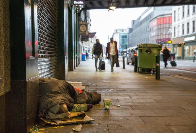 Homeless people sleeping on streets of Glasgow. A man lies sleeping under the 'Hielanman's' umbrella on Argyle Street. ..Picture Robert Perry 16th March 2017..Must credit photo to Robert Perry.FEE PAYABLE FOR REPRO USE.FEE PAYABLE FOR ALL INTE